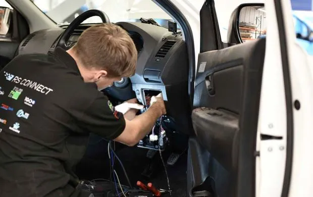 engineer installing devce to car