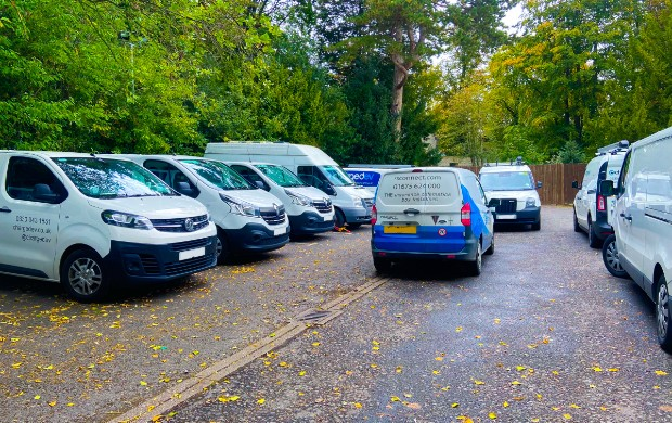 RS Connect engineer in car park to install tracking onto a fleet of white vans 