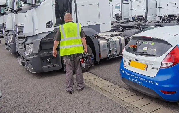 RS Connect engineer in car park installing DVS kit onto a white HGV fleet