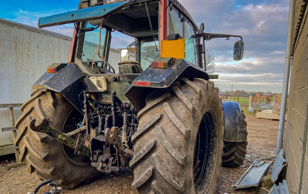 fitting a tracker onto a tractor on a farm